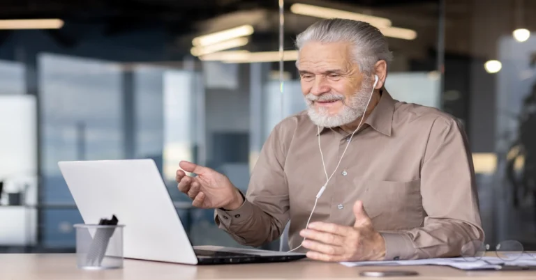 Retired man business coaching online from home