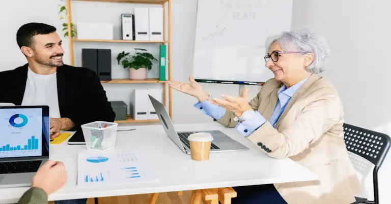 older woman coaching younger business peoiple