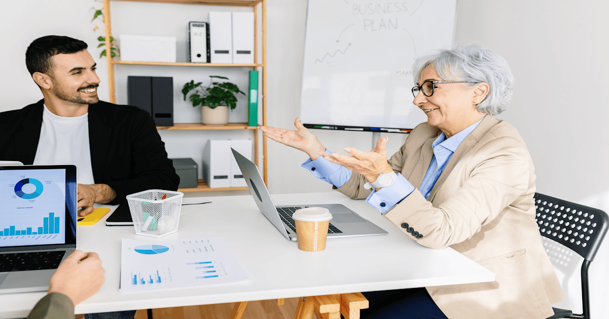 older woman coaching younger business peoiple